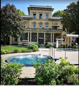 a large building with a swimming pool in front of it at Residenza Juvarra Deluxe in Turin