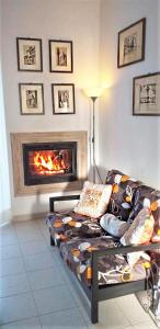 a living room with a couch and a fireplace at Casa Tonino in Pisticci