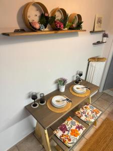 a dining room table with plates and dishes on it at Elichrysos GuestHouse Konitsa in Konitsa