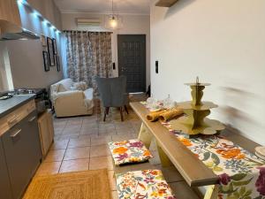 a kitchen with a table and a counter top at Elichrysos GuestHouse Konitsa in Konitsa +16 photos