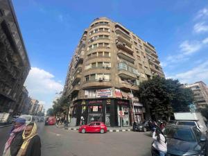a tall building with a red car parked in front of it at Luxury apartment Downtown Cairo in Cairo +57 photos
