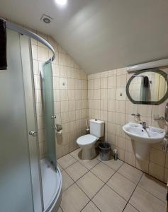a bathroom with a shower and a toilet and a sink at Keta in Marijampolė