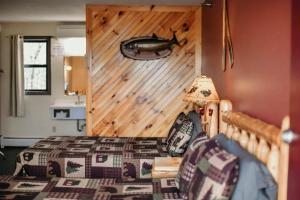 a bedroom with a bed and a wooden wall at Briarwood motor inn in Lincoln