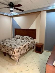 a bedroom with a bed and a ceiling fan at Hotel Hacienda el Edén in San Juan de los Lagos