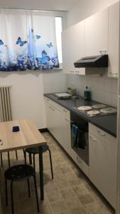 a kitchen with a table and a stove top oven at Pregassona Relaxing Home in Lugano