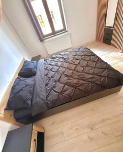 a large bed in a room with a window at Home central apartment Sibiu in Sibiu
