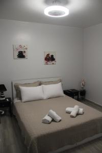 a bedroom with a bed with two towels on it at Apartment Patra Greece in Patra