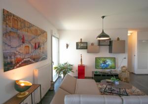 a living room with a couch and a tv at Appartement 97m2-Roof Top privé 100m2-Parking privé-Clim mobile in Nantes