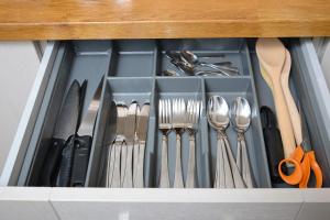 a drawer filled with utensils and forks and spoons at Southampton West with workspace and fast internet in Southampton