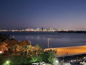 a view of a city from the water at night at Bayfront Apartment Breathtaking Views- one bedroom w balcony- living room -Free Parking in Miami Beach