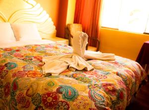 a bedroom with a bed with a comforter on it at PUNO ANDENES Suite in Puno