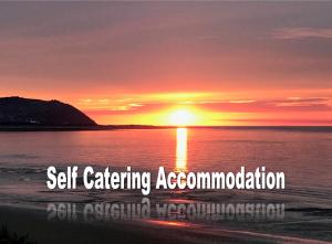 a sunset on the beach with the words self catering accommodation at Anchor's Drop in Blue Anchor