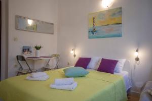 a bedroom with a green bed with two towels on it at Old Town Historic Core in Split