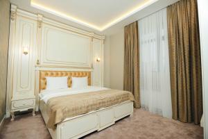 a bedroom with a large white bed in a room at The Krone in Baku