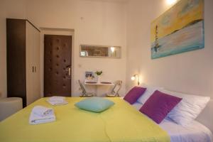 a bedroom with a large yellow bed with towels on it at Old Town Historic Core in Split +15 photos