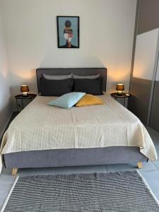 a bedroom with a large bed with two night stands at zonapartments A sea view-city center in Chania