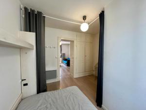 a bedroom with a bed and a hallway at Joli appartement plein centre ville in Gérardmer