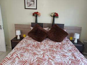 a bedroom with a large bed with two night stands at Serene on 5 Cologne in Germiston