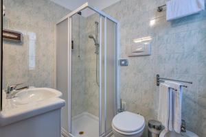 a bathroom with a shower and a toilet and a sink at Hotel Casa Piantoni in Limone sul Garda