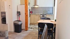 a small kitchen with a table and a refrigerator at El Dino in country cathare*PRO*Oc Keys011 in Espéraza