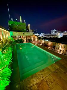 a swimming pool on top of a building at night at Hotel San Miguel Imperial in Santa Marta