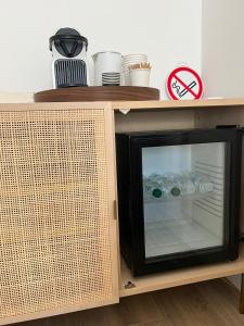 a microwave with its door open on a wooden cabinet at Great Room 29 in Mérignac