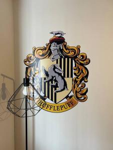 a shield on a wall with a military at Potters Escape- Warner Bros Studios & London in Leavesden Green