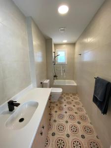 a bathroom with a sink and a tub and a toilet at Luxury Beach Living in Mountain View in Ras Elhekma +22 photos