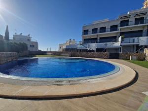 a large swimming pool in front of a building at Casa Buena Vista con piscina y ascensor in Cullera