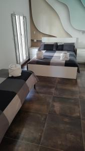 a bedroom with two beds and a large window at BariMetro Garden in Capurso