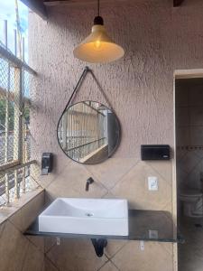 a bathroom with a sink and a mirror on the wall at Casa Grande Familia in Brasilia