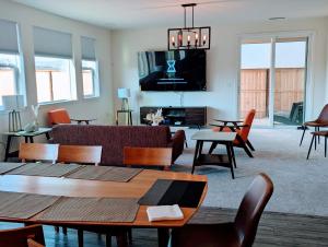 a living room with a couch and a tv at Modern, Spacious & Relaxing Home in Sparks, NV in Sparks