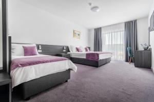 Postel nebo postele na pokoji v ubytování Hotel Novum