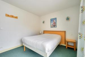 una camera con letto bianco di Résidence Le Montana - maeva Home - Appartement 2 pièces 6 personnes - Sé 394 a La Mongie