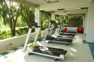 a row of tread machines in a gym with trees at Oasis Hotel Spa in Gravatá