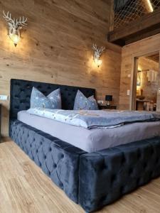 a bedroom with a large bed with a black headboard at Landgasthof Zur Linde in Kronach