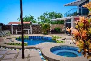 a swimming pool in front of a house at SeaSide Hotel in Puerto Baquerizo Moreno