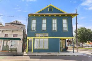 a blue and yellow house on the corner of a street at Marigny BD Surrounded by Music Food and Art in New Orleans
