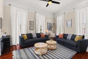 a living room with a blue couch and a table at Marigny BD Surrounded by Music Food and Art in New Orleans +13 photos