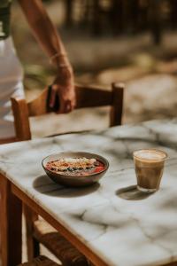 a bowl of food on a table with a cup of coffee at Ergon Beach House Nikiti in Nikiti
