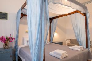 A bed or beds in a room at Irene Hotel Leros