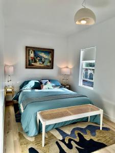 a bedroom with a large bed with a table on it at Modern, Bright 2BR Casita in Vibrant Echo Park Silver Lake with Gourmet Kitchen and Unbeatable Proximity to LA Hotspots in Los Angeles