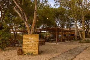 a tree in a wooden box in front of a restaurant at Ergon Beach House Nikiti in Nikiti