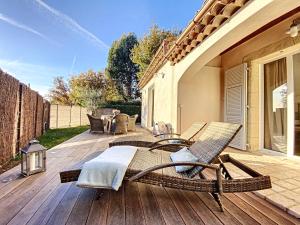 eine Terrasse mit Stühlen und einem Tisch auf einem Haus in der Unterkunft Villa "L'émeraude - Maison d'Hôtes - Jardin et parking privés - Valbonne in Valbonne