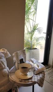 a cup of coffee on a table in a room with a window at Modern villa فلتي حديثه in Khamis Mushayt