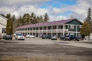 a large building with cars parked in a parking lot at Briarwood motor inn in Lincoln