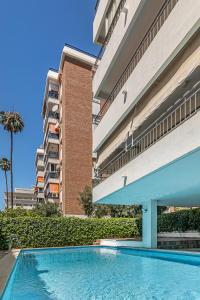 a swimming pool in front of a building at City Center Apartment in Marbella in Marbella