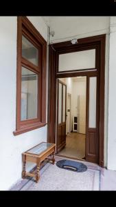 an open door with a bench in front of a room at Sweet Relax House in Budapest