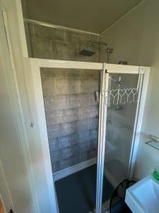 a shower with a glass door in a bathroom at Valley View 1 (Tourist board registered) in Tamnyrankin