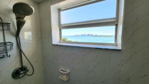 a shower in a bathroom with a window at Bayfront Apartment Breathtaking Views- one bedroom w balcony- living room -Free Parking in Miami Beach